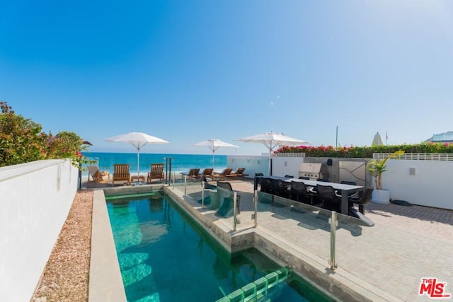 view of pool featuring a water view and a patio area