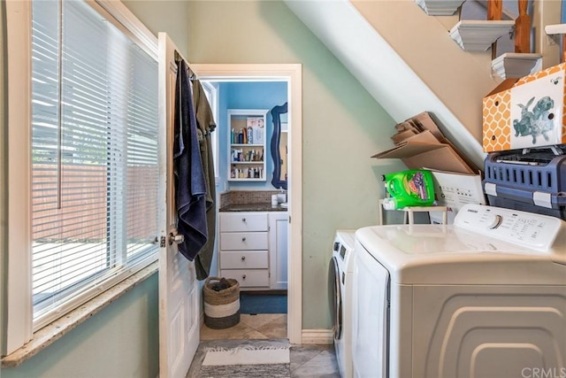 laundry room featuring light tile floors and washing machine and dryer