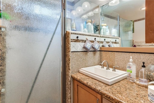 bathroom with tile walls, tasteful backsplash, and vanity with extensive cabinet space