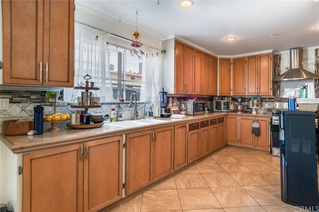 kitchen with sink, tasteful backsplash, light tile flooring, and wall chimney range hood