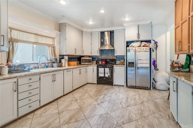 kitchen with sink, stainless steel appliances, light tile floors, wall chimney range hood, and tasteful backsplash