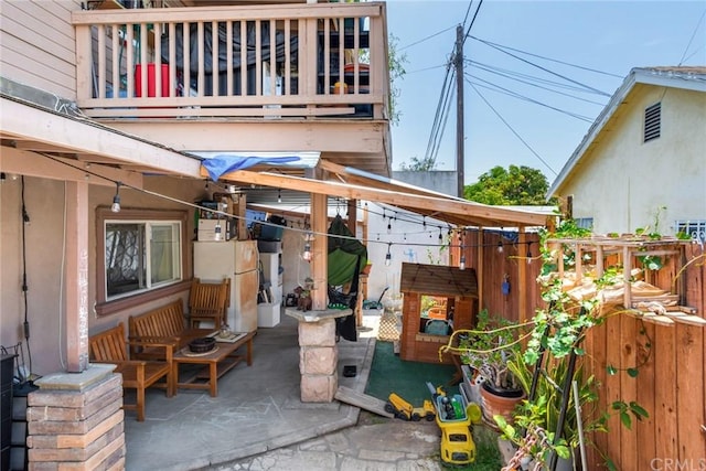 view of patio featuring a balcony