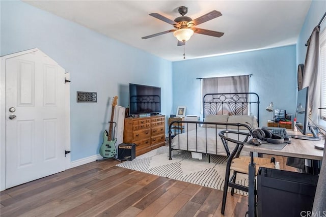 bedroom with dark hardwood / wood-style flooring