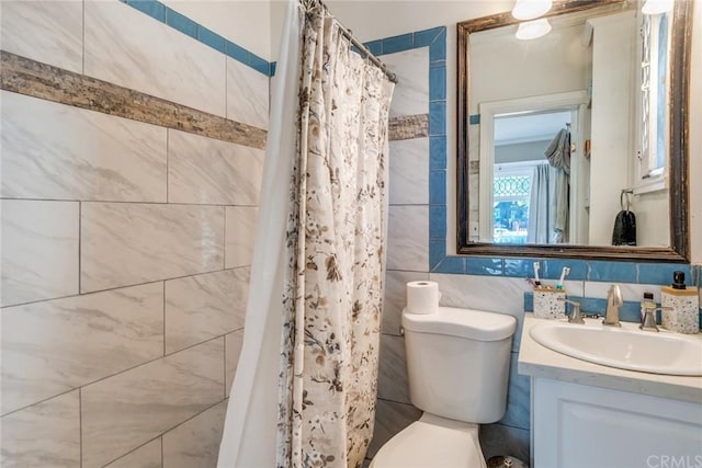 bathroom featuring tile walls, toilet, ornamental molding, tasteful backsplash, and vanity