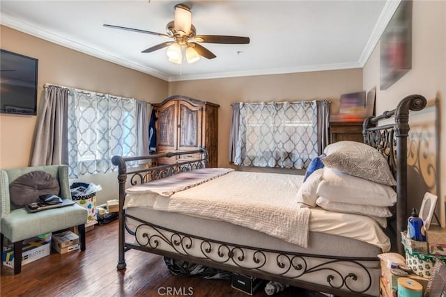 bedroom featuring dark hardwood / wood-style floors, ornamental molding, and ceiling fan