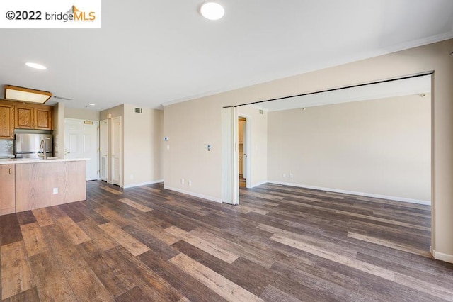 unfurnished living room with dark wood-type flooring