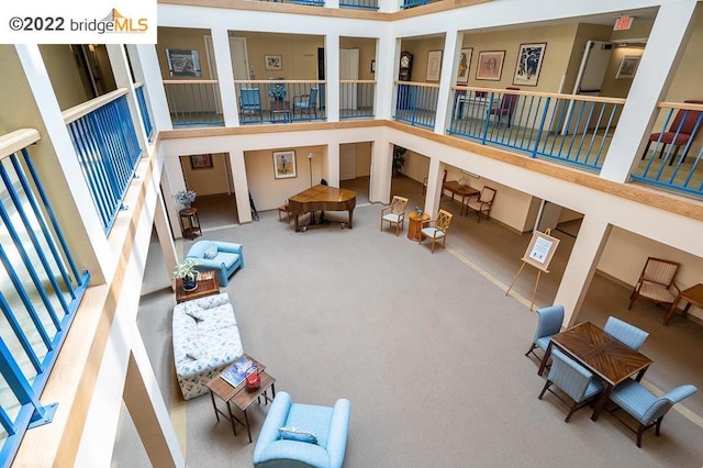 interior space featuring carpet and a high ceiling