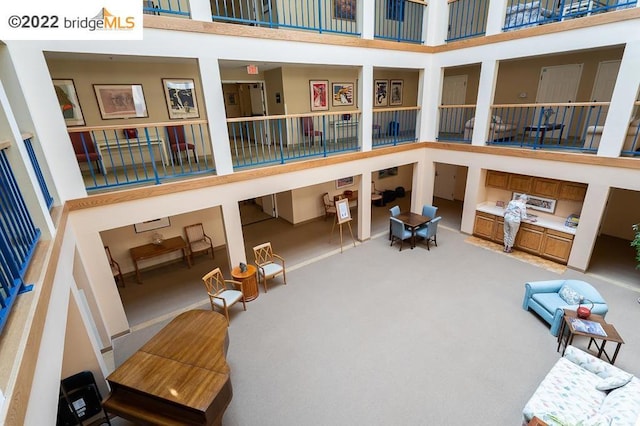 interior space with carpet flooring and a towering ceiling