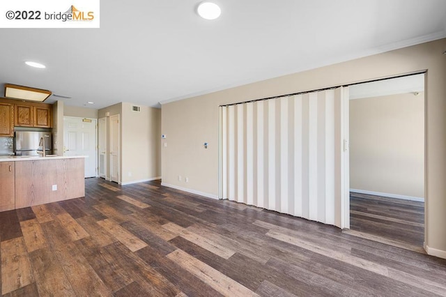 unfurnished living room with dark wood-type flooring