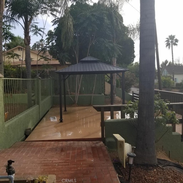 exterior space with fence and a gazebo