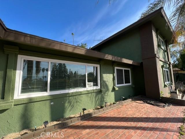 view of side of property with a patio and stucco siding