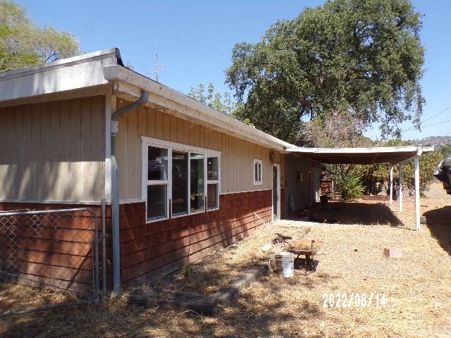 view of property exterior featuring a carport