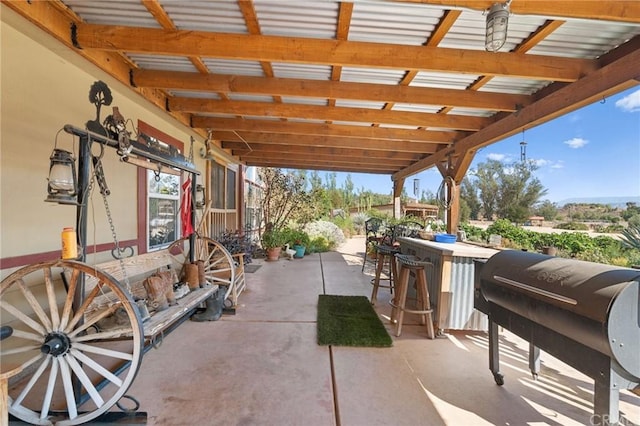 view of terrace with an outdoor bar and area for grilling