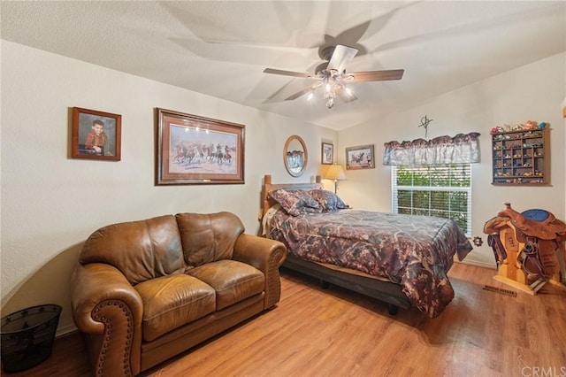 bedroom featuring ceiling fan, vaulted ceiling, and light hardwood / wood-style floors