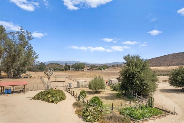 view of yard featuring a rural view and a mountain view