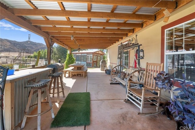 view of patio featuring exterior bar and a mountain view