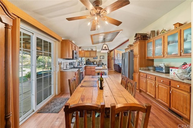 dining room with ceiling fan and light hardwood / wood-style flooring