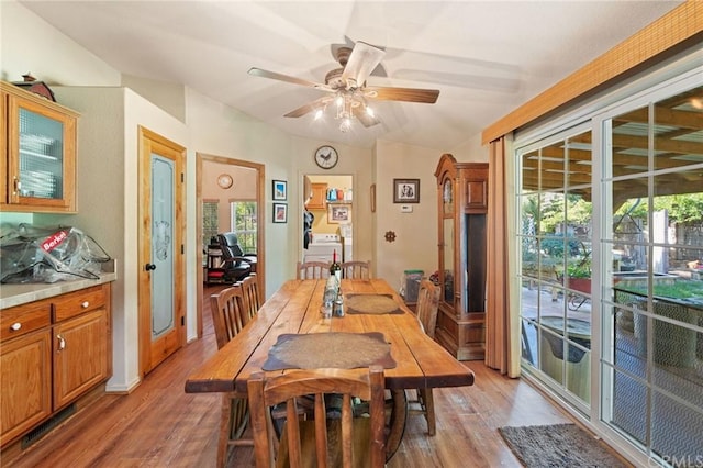 dining area featuring washer / clothes dryer, ceiling fan, and light hardwood / wood-style floors