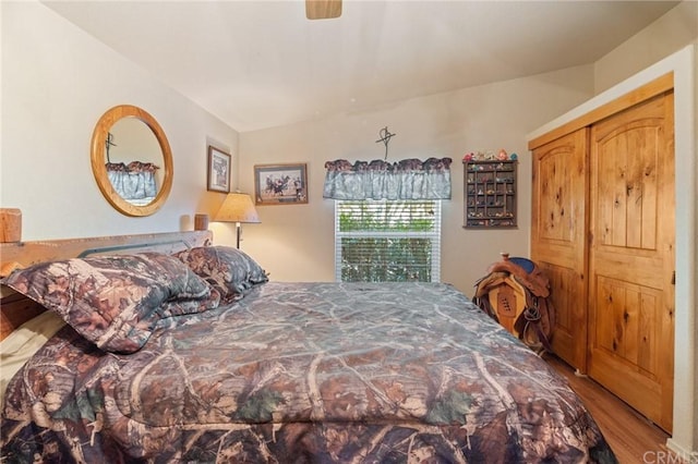 bedroom featuring lofted ceiling, ceiling fan, and light hardwood / wood-style flooring