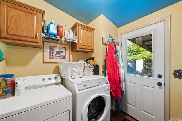 laundry room featuring independent washer and dryer and cabinets