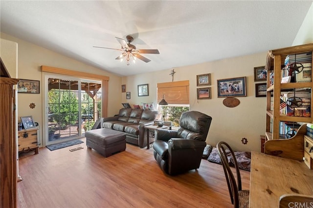 living room featuring lofted ceiling, ceiling fan, and light wood-type flooring