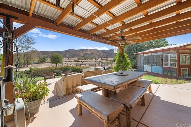 view of patio / terrace featuring ceiling fan and a mountain view