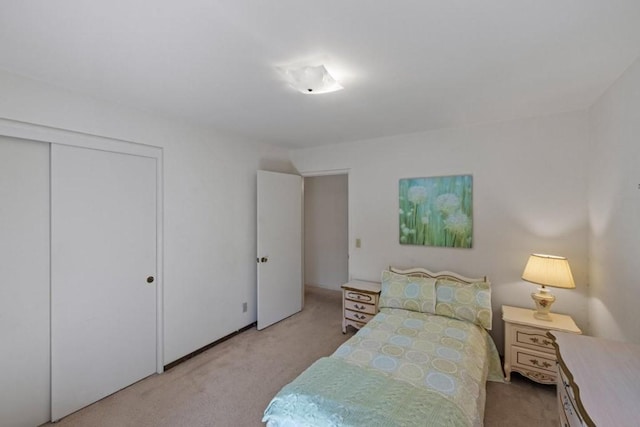 bedroom with light carpet and a closet