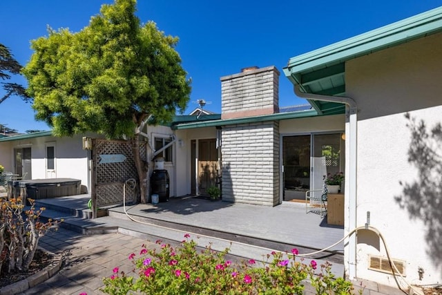 exterior space with a deck and a hot tub