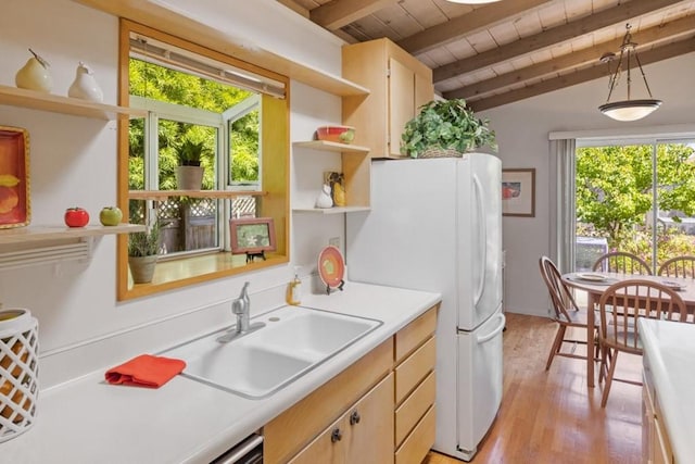 kitchen featuring sink, white refrigerator, light hardwood / wood-style flooring, lofted ceiling with beams, and wooden ceiling