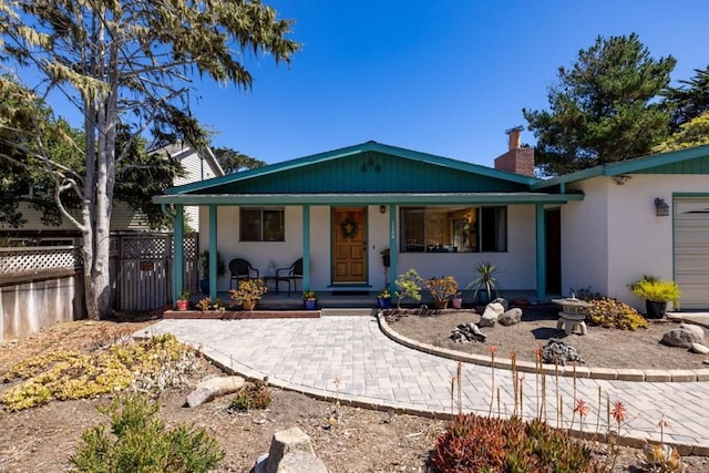 rear view of property featuring a porch