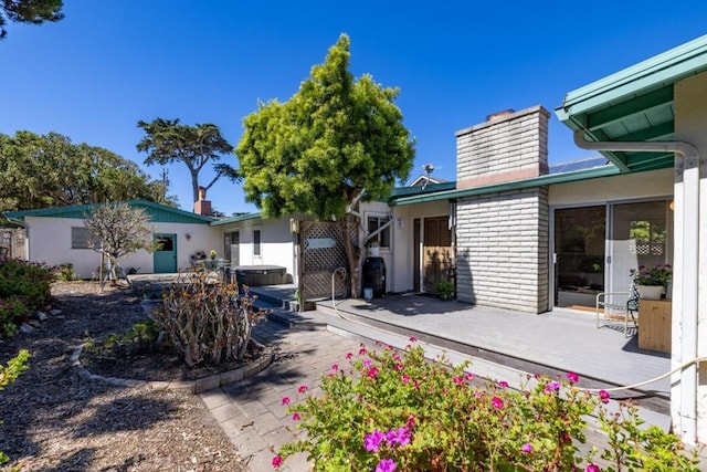 rear view of property featuring a wooden deck