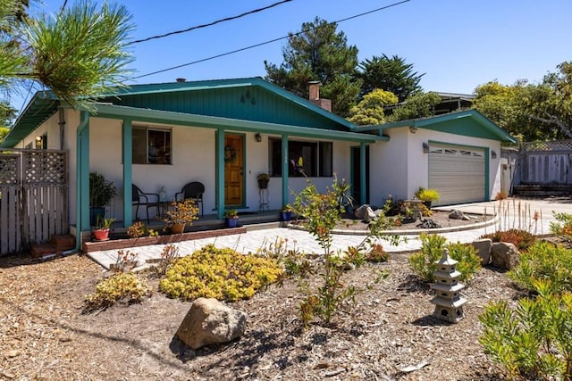 view of front of property featuring covered porch and a garage