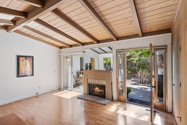 interior space with lofted ceiling with beams and hardwood / wood-style floors