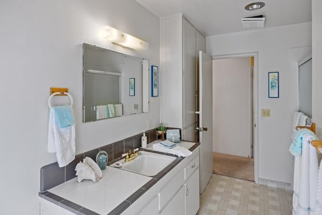 bathroom with vanity and tile flooring