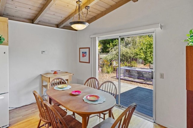 dining room featuring wood ceiling, vaulted ceiling with beams, and light wood-type flooring