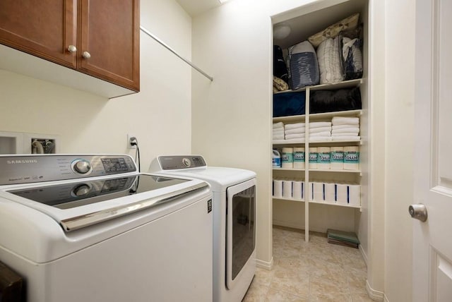 laundry room featuring washer hookup, cabinets, independent washer and dryer, and light tile floors