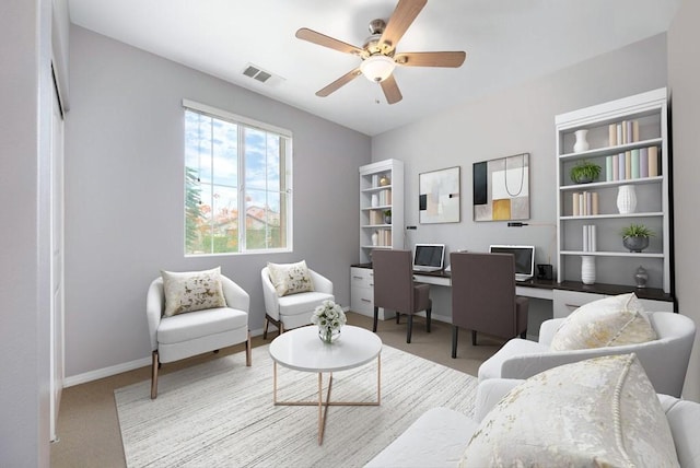 carpeted home office featuring ceiling fan