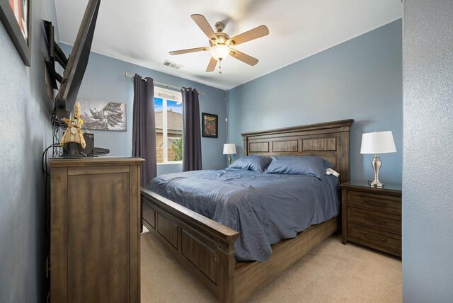 bedroom with ceiling fan and light colored carpet