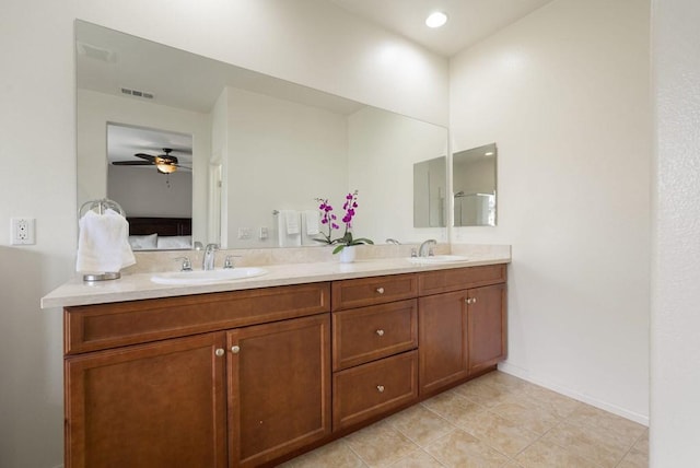 bathroom with oversized vanity, tile floors, dual sinks, and ceiling fan