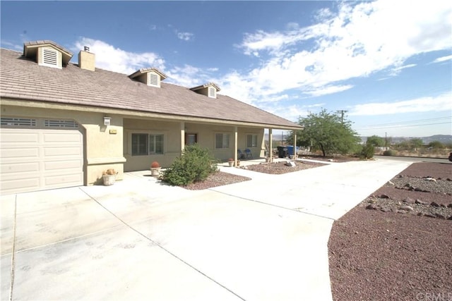 rear view of property featuring a garage