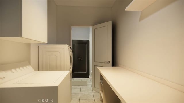 clothes washing area featuring washer / dryer and light tile patterned flooring