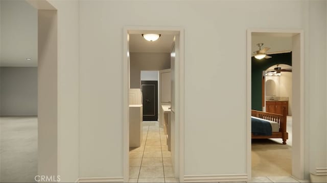 hall with light tile patterned floors