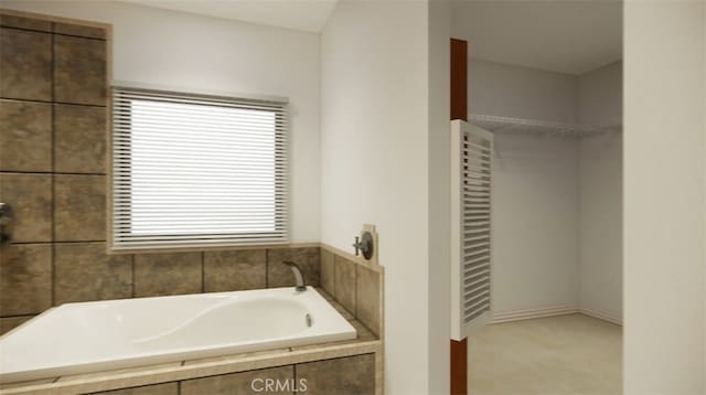 bathroom featuring tiled tub