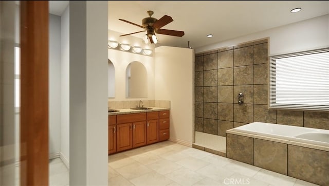 bathroom with vanity, tile patterned floors, ceiling fan, and plus walk in shower