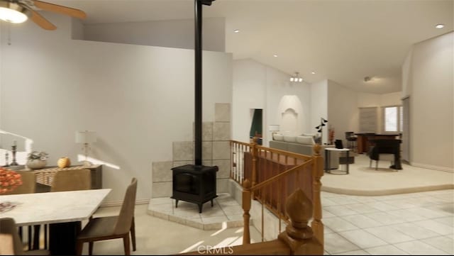 living room with light tile patterned floors, high vaulted ceiling, ceiling fan, and a wood stove