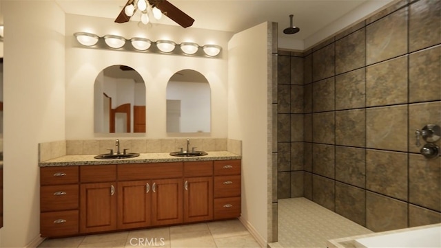 bathroom with vanity, a tile shower, tile patterned floors, and ceiling fan