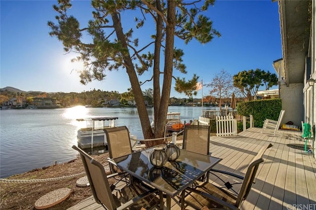 deck with a boat dock and a water view