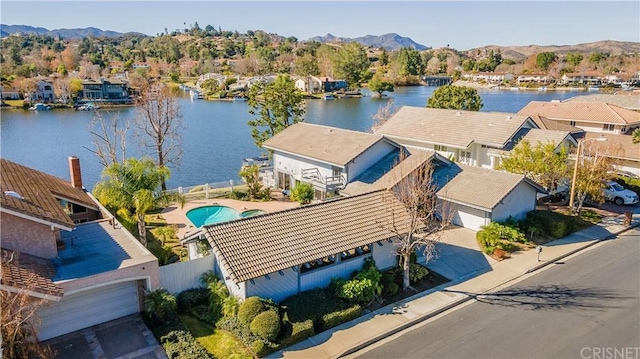 birds eye view of property with a water and mountain view