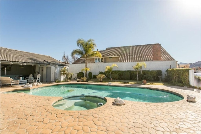 view of swimming pool featuring a patio area and an in ground hot tub