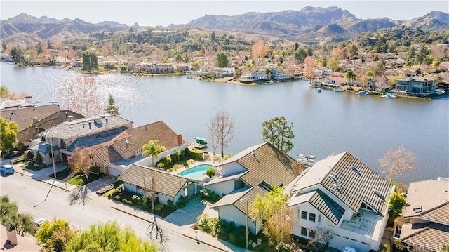 drone / aerial view featuring a water and mountain view